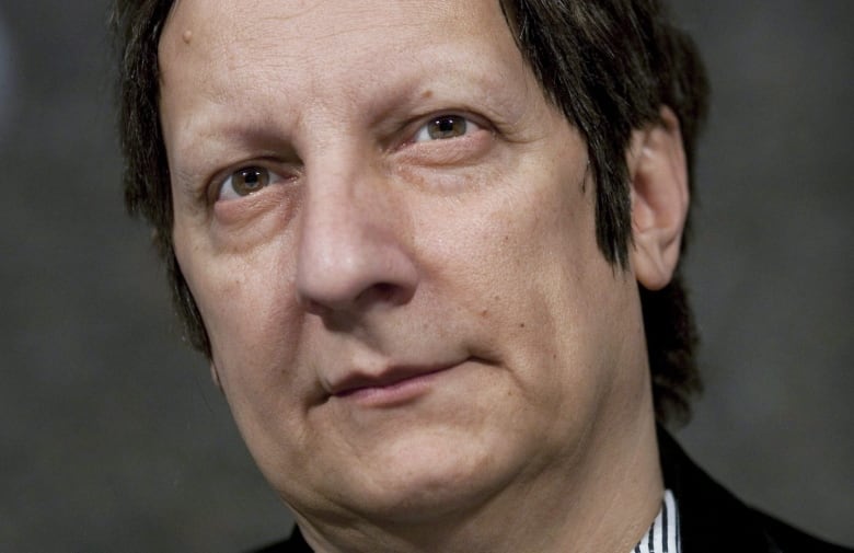 A close up image of Canadian actor and film director Robert Lepage. He has brown eyes and short brown hair.