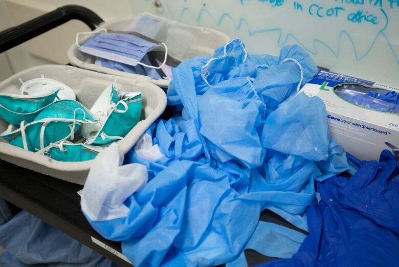 A pile of blue masks and hospital gloves. 