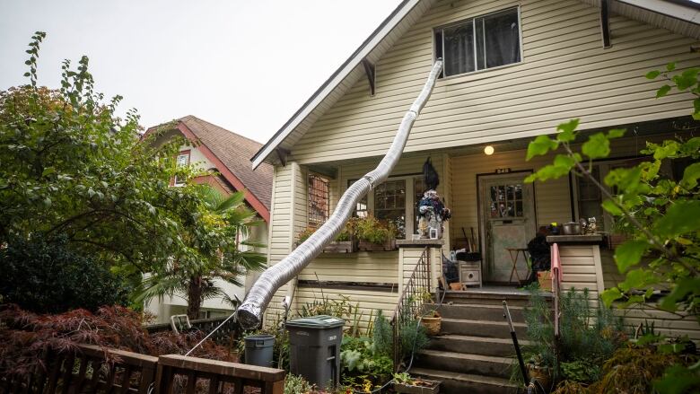 A chute descends from the top floor of a single-family house in Vancouver during Halloween.