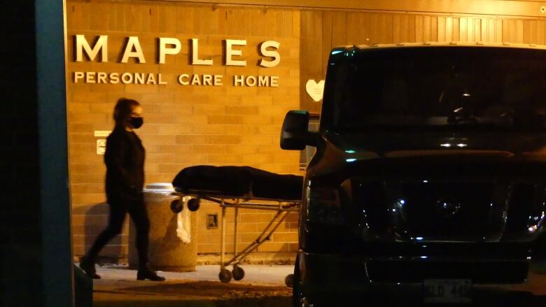 A stretcher is seen outside the Maples Personal Care Home.