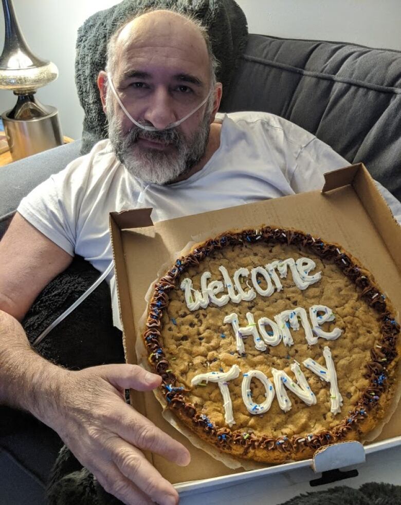 Tony Passarelli holding a welcome home cookie.