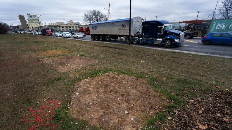 A yellowed patch of grass in the place where a homeless encampment was dismantled in Montreal in 2020. 