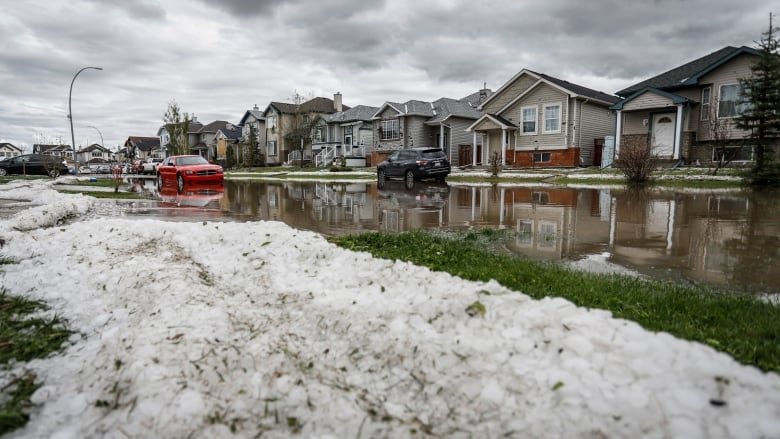 Hail and flooding against a landscape of homes in northeast Calgary.