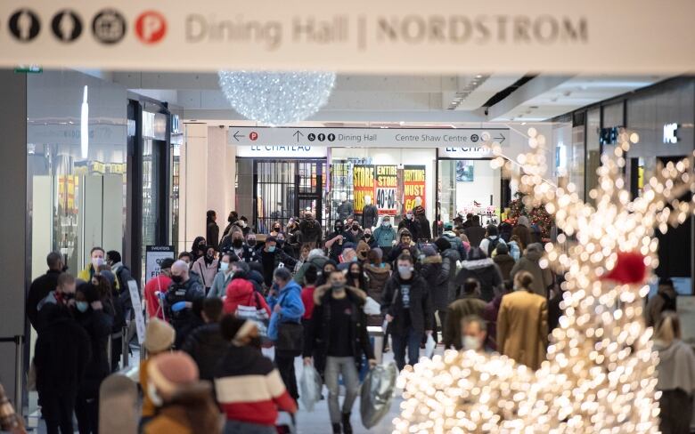 People shop on Christmas Eve at the Rideau Centre in Ottawa, Thursday, Dec. 24, 2020. 