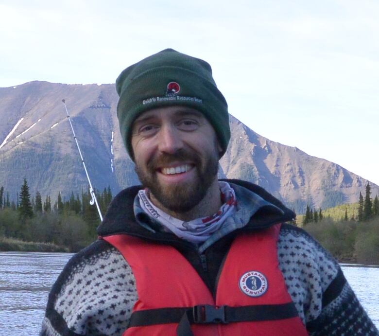 Young man in life jacket, tuque.