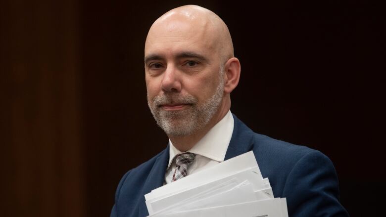 Parliamentary Budget Officer Yves Giroux waits to appear before the Commons Finance committee on Parliament Hill in Ottawa, Tuesday March 10, 2020. In a new report, Giroux says Liberal reforms to the fiscal stabilization program will increase its cost by  will increase by $2.9 billion in fiscal year 2021-22.