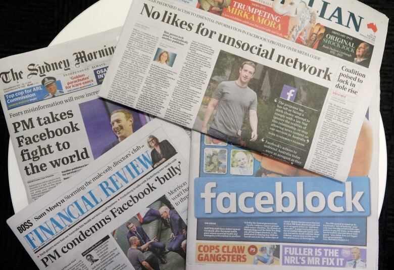 Front pages of Australian newspapers are displayed featuring stories about Facebook in Sydney, on Friday. In a surprise retaliatory move Thursday, Facebook blocked Australians from sharing news stories, escalating a fight with the government over whether powerful tech companies should have to pay news organizations for content. (AP Photo/Rick Rycroft)