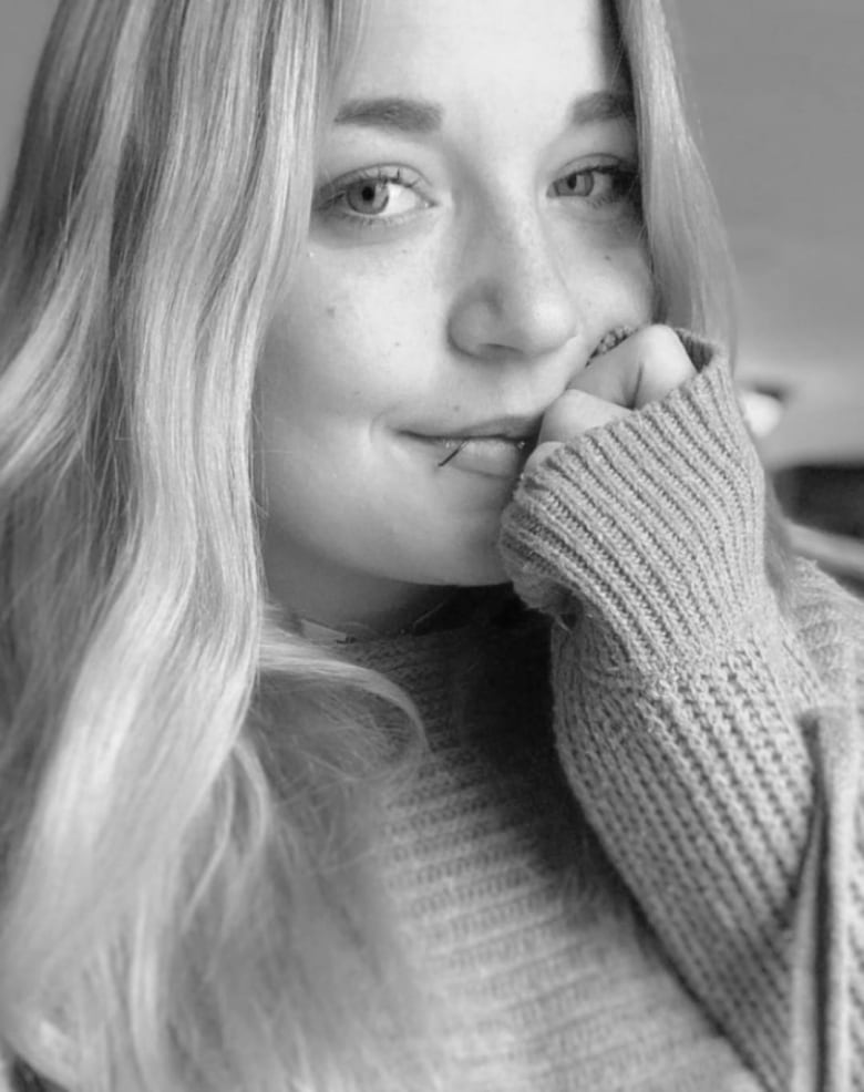 A black-and-white picture of a woman with two lip piercings.