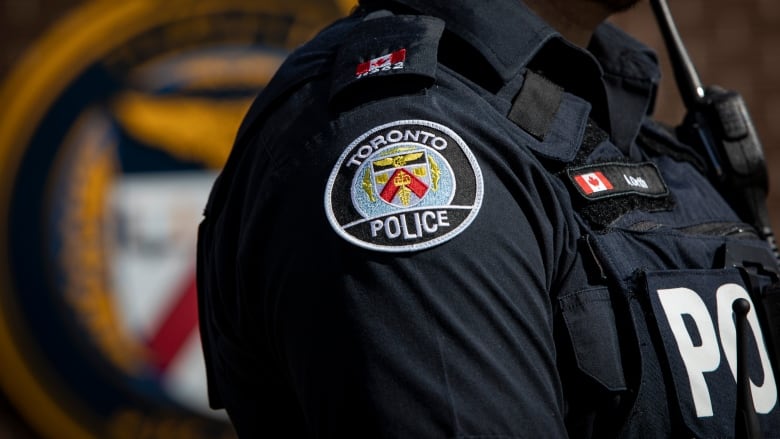 A Toronto Police office uniform logo is pictured. 