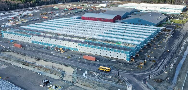 An industrial work camp is seen with modular temporary rows of buildings.