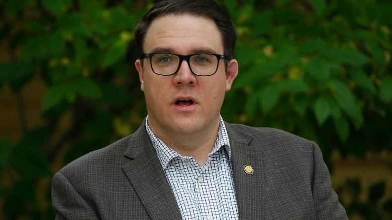 A man with glasses and dark hair. 