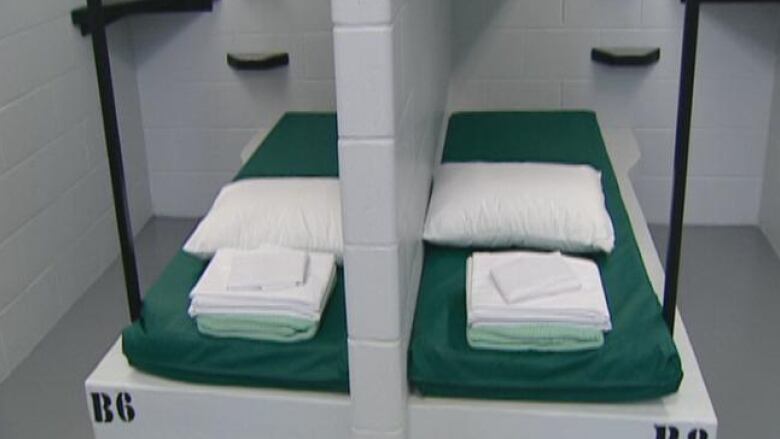 Photo of two bunks in a room with concrete walls