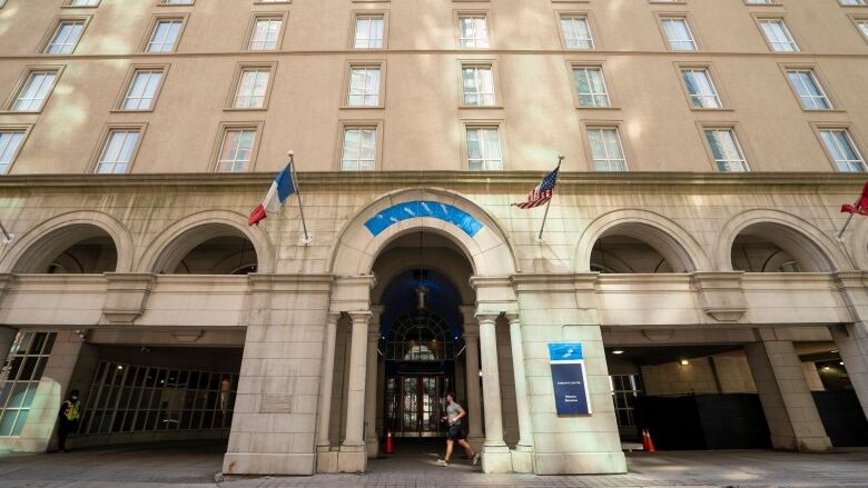 A man runs past the Novotel Toronto Centre hotel at 45 The Esplanade on Thursday, March 25, 2021.