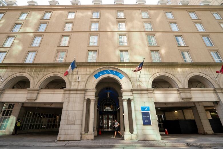 A man runs past the Novotel Toronto Centre hotel at 45 The Esplanade on Thursday, March 25, 2021.