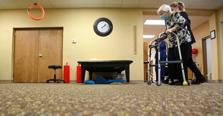 A photo of a resident and worker inside a long-term care home.