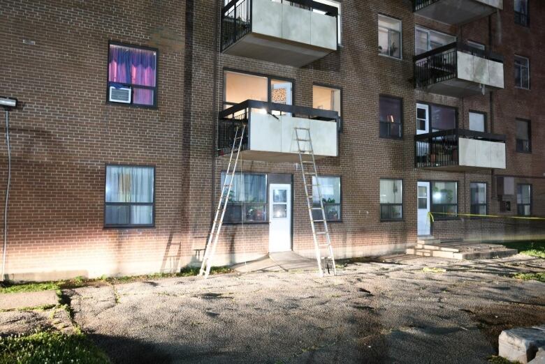 Ladders used by police can be seen propped against the balcony of Ejaz Choudry and his family's apartment in Mississauga on June 20, 2020.