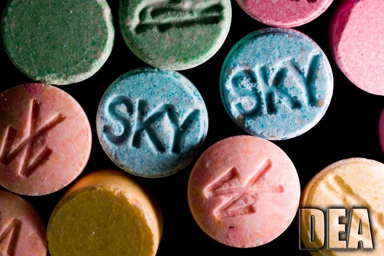 Green, pink and blue ecstasy pills.