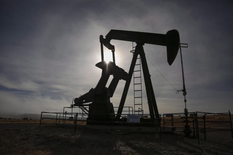 A pumpjack works at a wellhead on an oil and gas installation near Cremona, Alta., Saturday, Oct. 29, 2016. Higher oil prices in the wake of a U.S. air strike in Iraq that killed a top Iranian general are driving up share prices for Canadian energy companies and threatening higher fuel prices for consumers in Canada. 