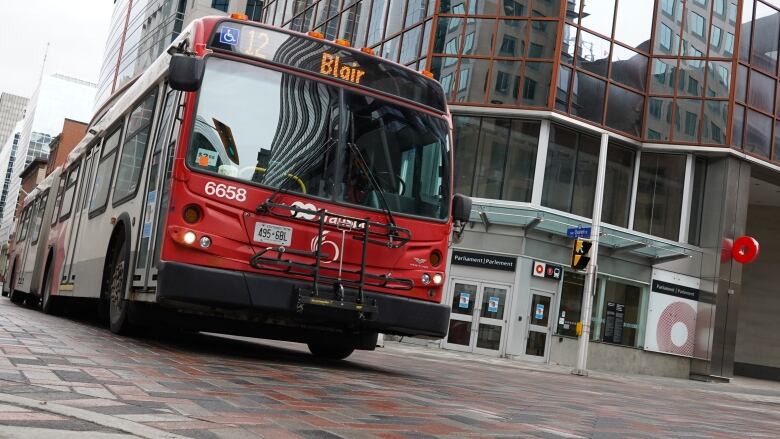 A red number 12 Blair bus drives through an intersection