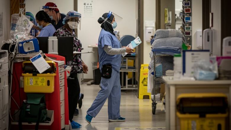 Nurses wearing personal protective equipment walk through the emergency department at Scarborough General Hospital, in north-east Toronto, on Apr. 8, 2021.