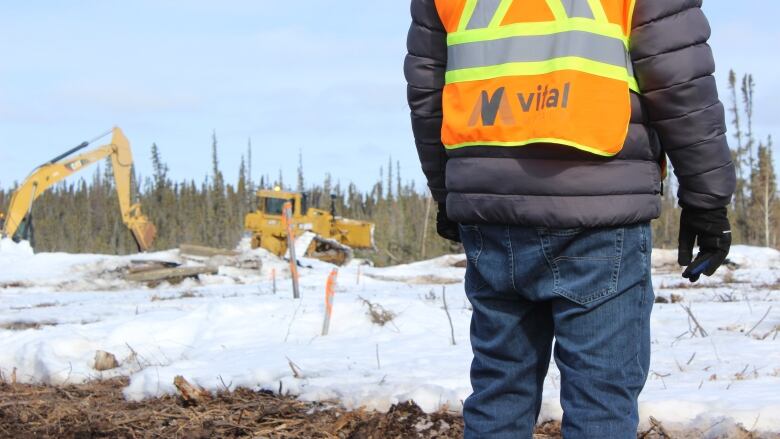 A man wearing a safety vest with the word 