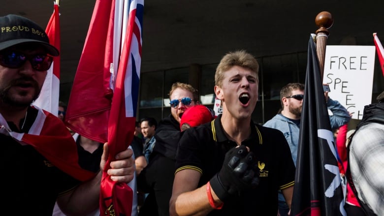 Members of the Proud Boys shout at a group of counter-protestors at Nathan Philips Square in Toronto on Saturday, October 21, 2017. 