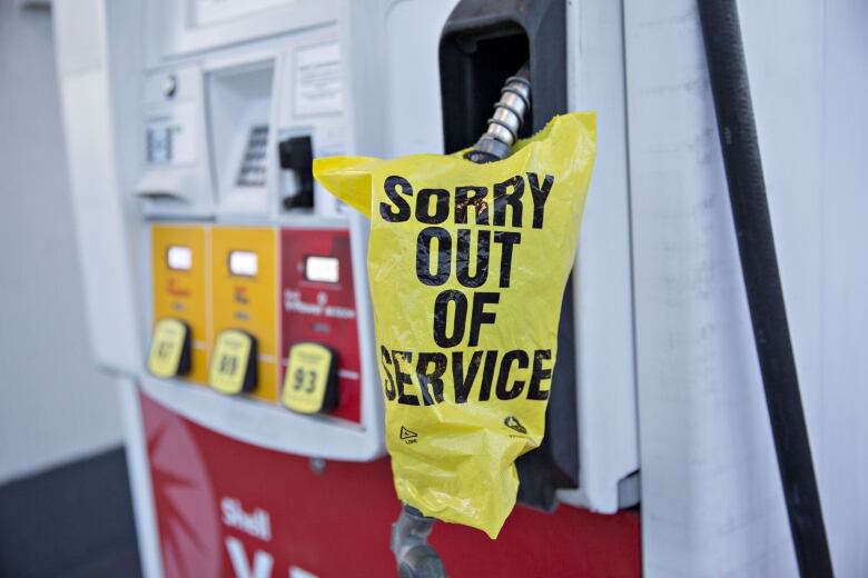 An out of service bag covers a gas pump.