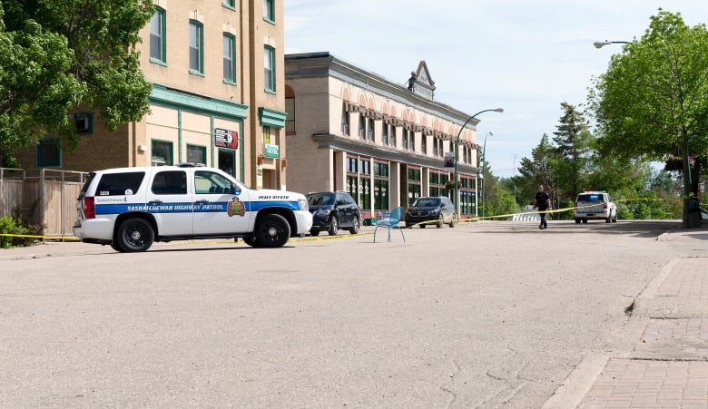 RCMP vehicles are seen i=on a street in a small town