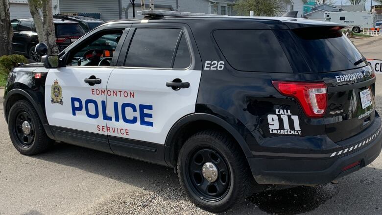 An Edmonton Police Service SUV blocks a street before a closed sign.