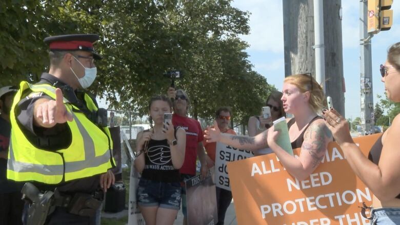 An animal rights activist is ticketed outside Fearman's Pork Inc. in Burlington on June 20, 2021, just over one year after Regan Russell died after being hit by a truck there.