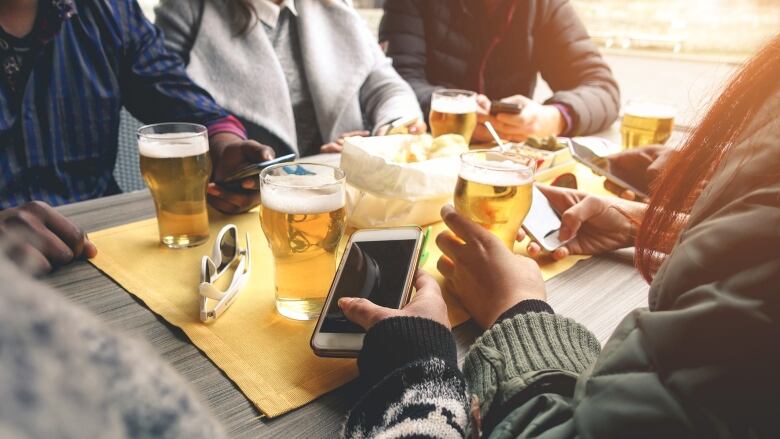 people sitting around a table with drinks 