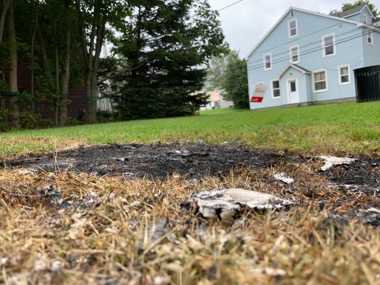 A patch of burned grass on a lawn