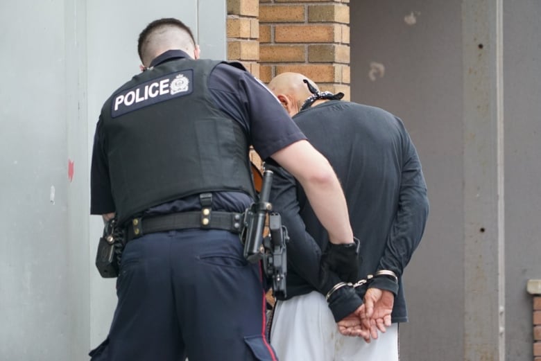 A London police officer makes an arrest in the city's core. 