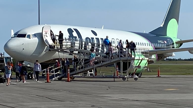 people getting off airplane