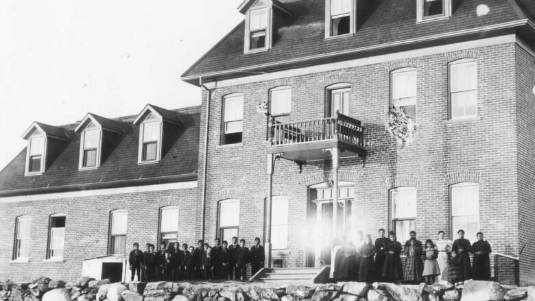 A black and white photo of a residential school building. 