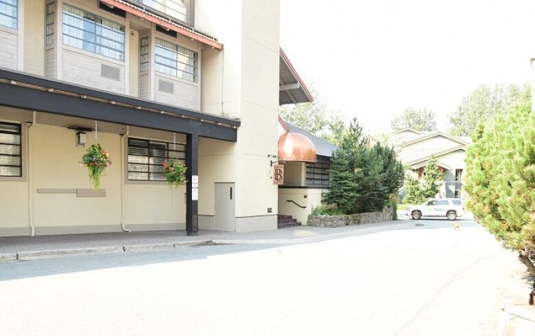 A Whistler parking lot sits in front of what appears to be a motel or other commercial building.