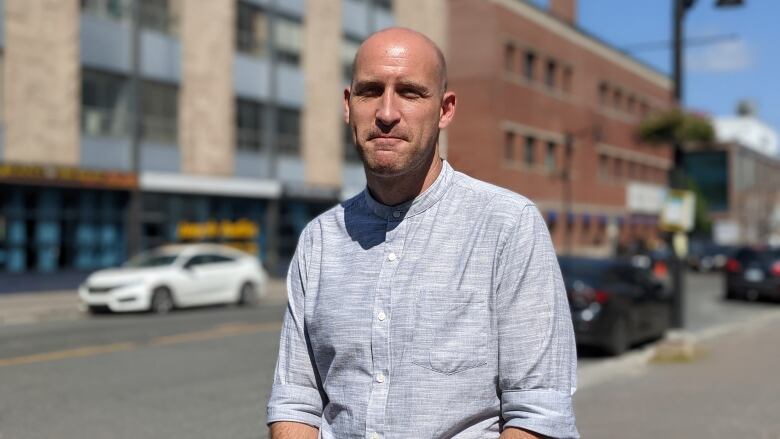 A man standing on a downtown street.