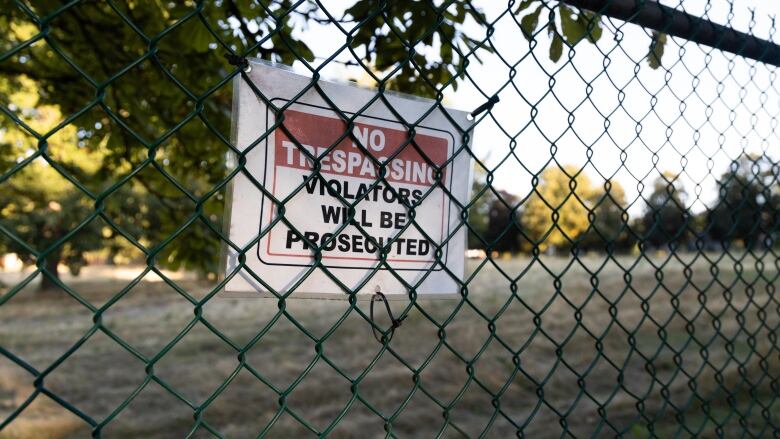 No trespassing sign on a fence.