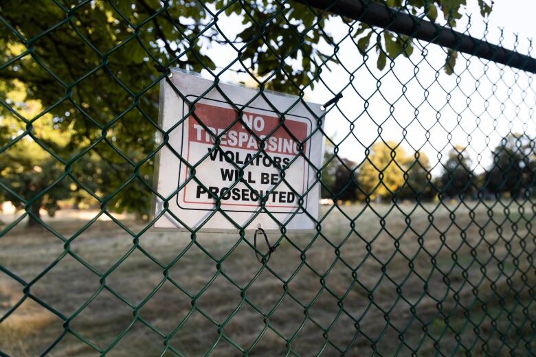 No trespassing sign on a fence.