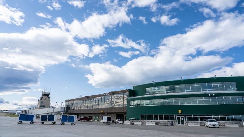 A small airport building is seen from the tarmac.