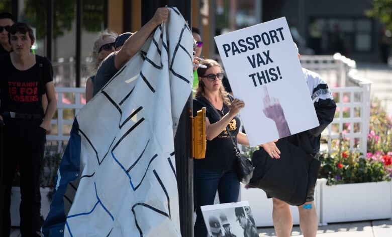 Protesters gather to protest COVID-19 restrictions including the new B.C. vaccine card outside of Vancouver City Hall on Sept. 8, 2021.