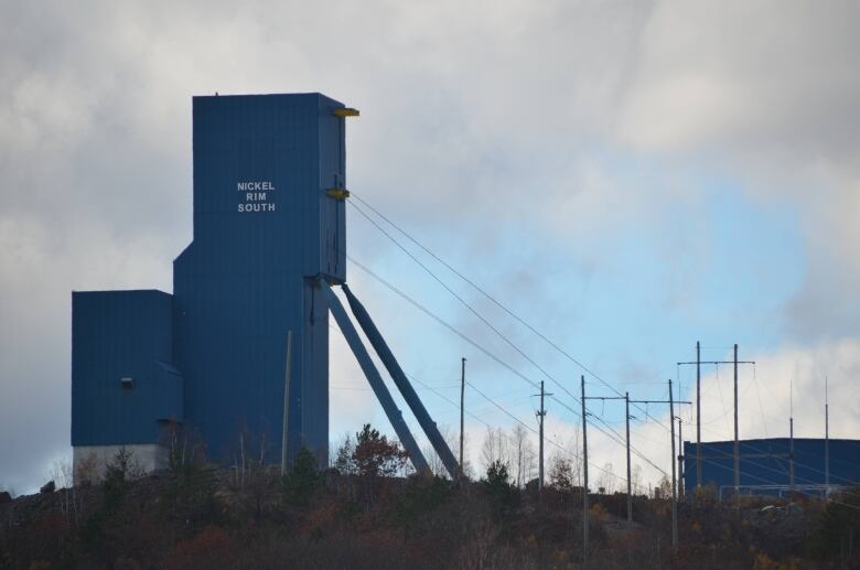 A mine headframe silhouetted against the sky.