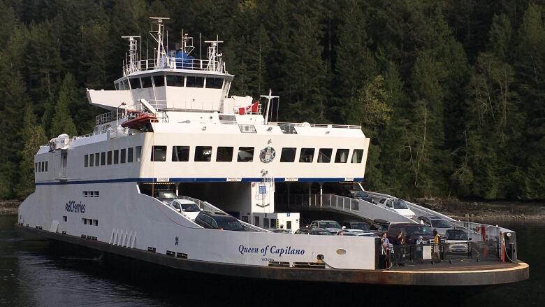 A vessel with multiple cars on board titled the 'Queen of Capilano'.