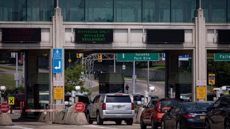 Cars bound for Canada line the Rainbow International Bridge, in Niagara Falls, on Aug. 9, 2021. Canada now allows fully vaccinated Americans to both enter the country and skip the previously mandatory 14-day quarantine period as part of an easing of COVID-19 restrictions on travel.