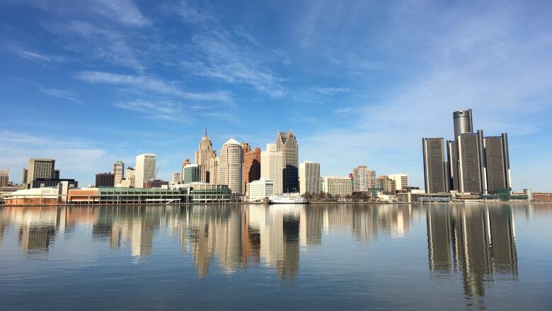 Buildings reflecting on a river.