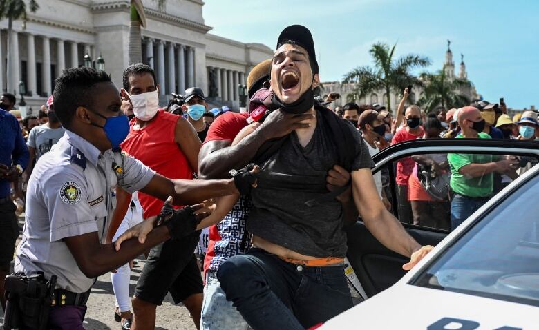 A man is arrested during a demonstration against the government of Cuban President Miguel Diaz-Canel in Havana, on July 11, 2021.