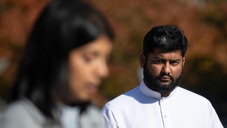 Aarij Anwer, Imam of the London Muslim Mosque (right) looks over at Nadia Hasan, Chief Operating Officer of National Council of Canadian Muslims, as they  attend a press briefing outside the Queens Park Legislature, in Toronto, on Monday November 8, 2021. The National Council of Canadian Muslims (NCCM) together with the London Muslim Mosque (LMM) and members of the London Muslim community  are calling  call on the Ontario government to introduce and pass legislation to tackle violent and systemic forms of Islamophobia in the province in the aftermath of the London Terror Attack.  THE CANADIAN PRESS/Chris Young