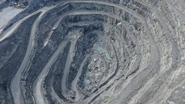 An aerial image of an open pit gold mine.