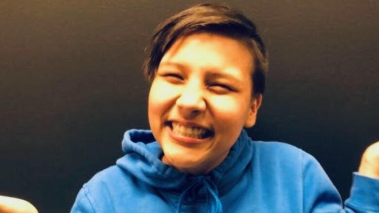 A headshot of a young girl wearing a blue hoodie.