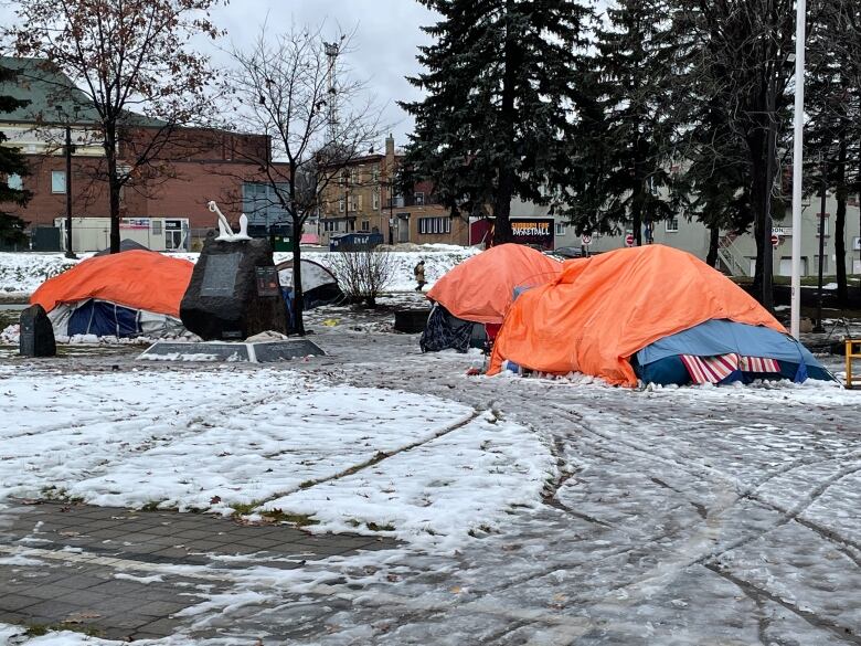 Pictures of tents in a downtown park.